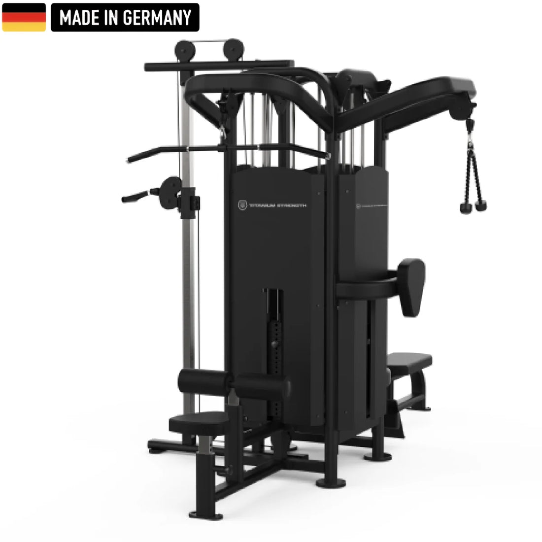 Multi-functional black gym machine with various attachments, including a cable pulley system, adjustable weight stacks, a seated row station, and a Smith machine bar. The equipment is labeled "Titanium Strength" and features a "Made in Germany" badge with the German flag in the top left corner.