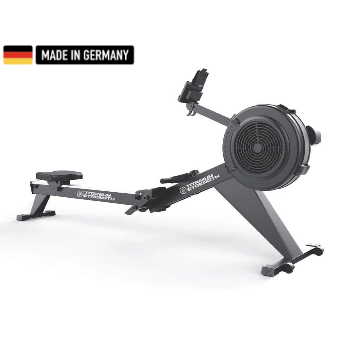 Titanium Strength rowing machine featuring a sleek black design with a built-in digital console, foot pedals, and a durable flywheel. A 'Made in Germany' badge is displayed in the top left corner.