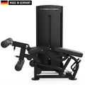 A sleek, black Titanium Strength gym machine with padded leg supports and adjustable features, labeled 