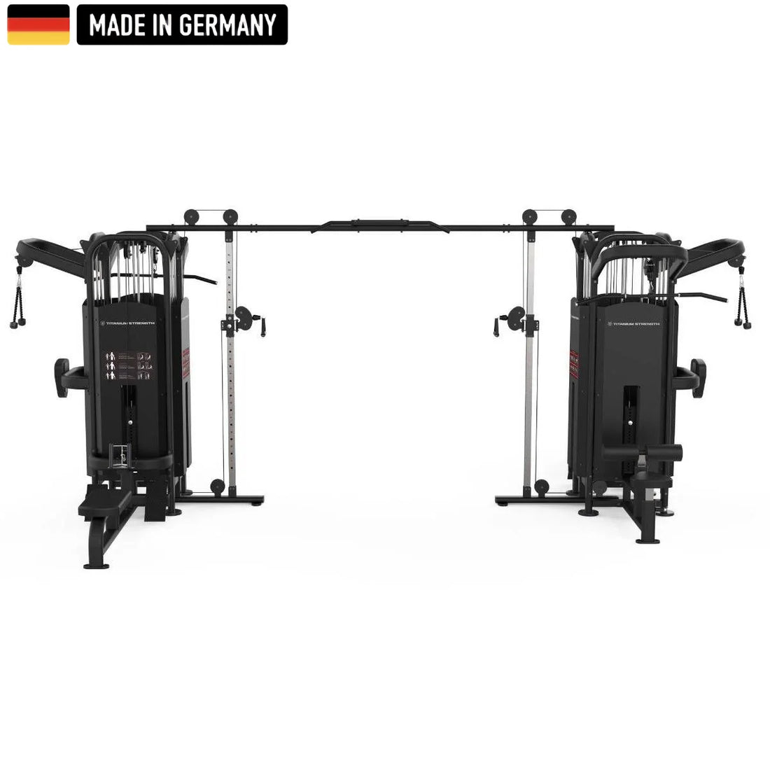 Large multi-station gym machine in black, featuring multiple cable pulleys, adjustable weight stacks, pull-up bars, seated row stations, and Smith machine bars. The equipment is branded "Titanium Strength" and includes a "Made in Germany" badge with the German flag in the top left corner.