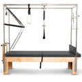  A pilates table featuring a sturdy metal frame and a sleek black mat, designed for effective workouts and exercises.