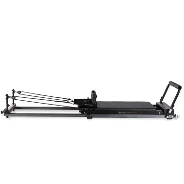 Elina Pilates Domo Reformer – compact, foldable Pilates reformer made of aluminum with adjustable footboard and transport wheels.
